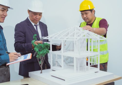 A male engineer and  contractor desk  an office discuss the structural design house,roof drafting
