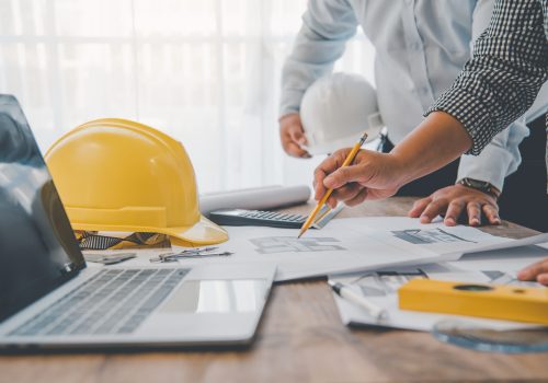 engineer working in office with blueprints, inspection in workplace for architectural plan, construction project ,Business construction